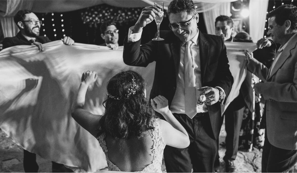 bride dancing with the groom surrounded by their guests