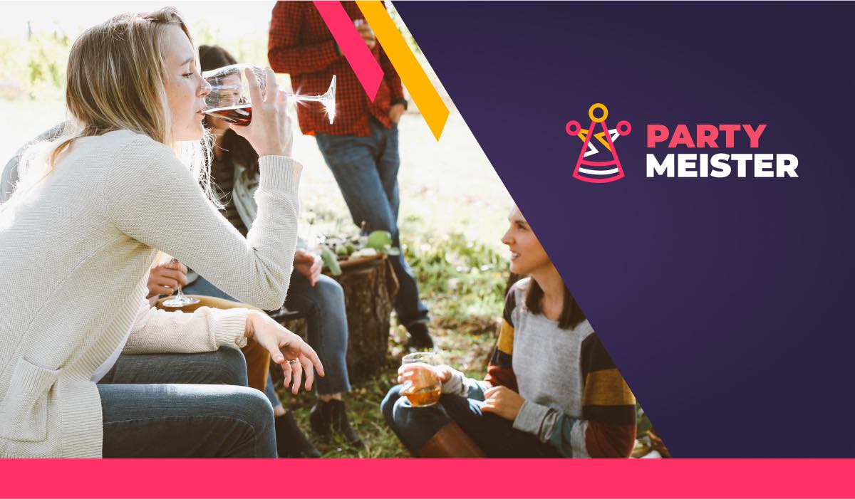 Women sit in a circle drinking wine. A PartyMeister logo