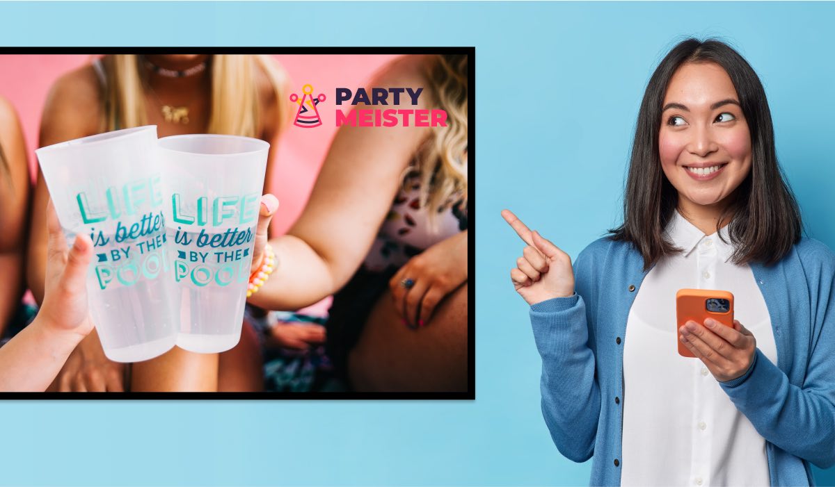 A woman with a phone in her hand points at a TV with two hands holdinng a cup each and a PartyMeister logo