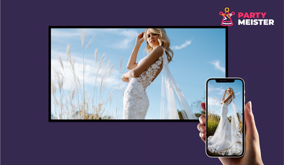 An iPhone with the PartyMeister app displaying an image of a bride in a wedding dress. the same image appears on a Smart TV screen. There's a PartyMeister logo in the corner